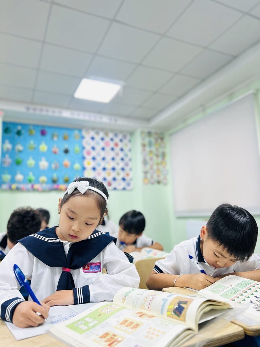 Primary school students working in their textbooks